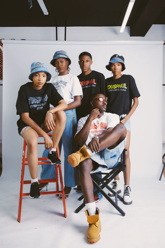 Home Group of stylish young adults in casual fashion posing indoors, showcasing modern streetwear.