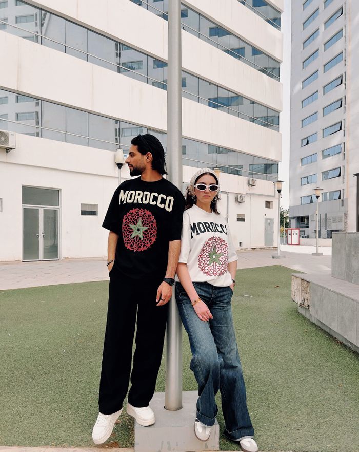 Fashionable duo in urban setting wearing Morocco print t-shirts.